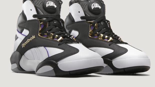 Side view of Shaquille O'Neal's black and white Reebok sneakers.
